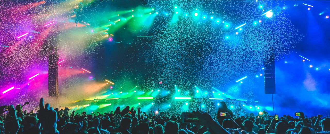 imagen colorida que muestra un escenario iluminado y confeti lanzado al aire